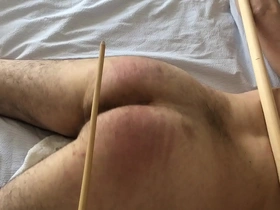 Caned cuffed to poles - no escape