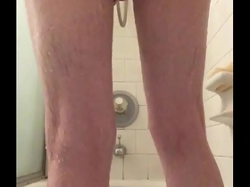 Skinny guy shaving in shower