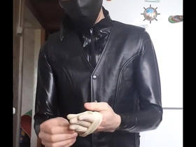 Guy in leather jacket putting gloves